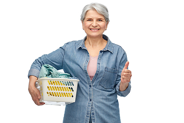 Image showing smiling senior woman with laundry basket