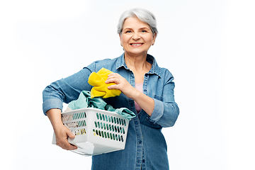 Image showing smiling senior woman with laundry basket