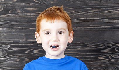 Image showing red-headed boy and blueberry