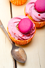 Image showing pink berry cream cupcake with macaroon on top