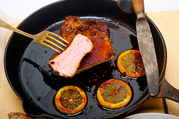 Image showing pork chop seared on iron skillet