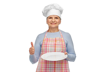 Image showing smiling senior woman or chef holding empty plate