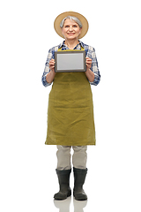 Image showing happy senior woman in garden apron with tablet pc