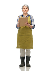 Image showing smiling old woman in garden apron with clipboard