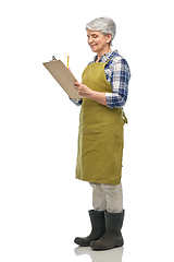 Image showing smiling old woman in garden apron with clipboard