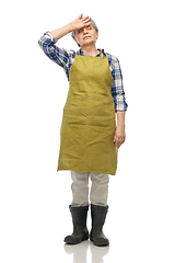 Image showing tired senior woman in garden apron