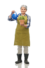 Image showing senior gardener with flower and watering can