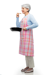 Image showing smiling senior woman in apron with frying pan