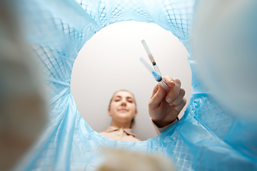 Image showing woman throwing used syringes into trash can