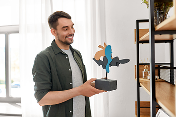 Image showing man decorating home with art in frame