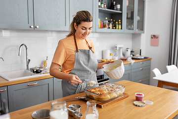 Image showing woman cooking food and baking buns at home kitchen