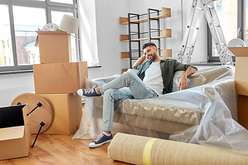 Image showing happy man with boxes moving to new home