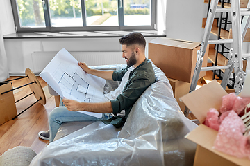 Image showing happy man with blueprint moving to new home