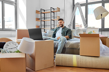 Image showing man with laptop computer and moving into new home