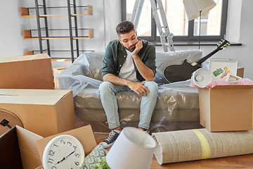 Image showing sad man with boxes moving to new home