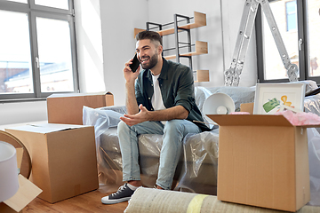 Image showing happy man calling on smartphone moving to new home