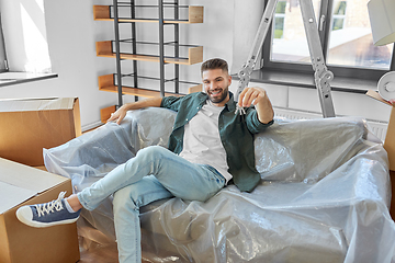 Image showing man with house keys and boxes moving to new home