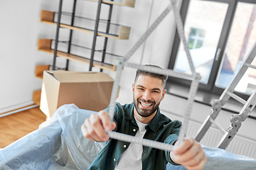 Image showing happy man with boxes moving to new home