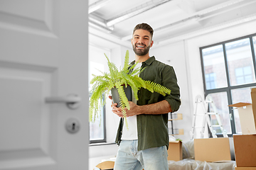 Image showing happy man with fern flower and moving to new home