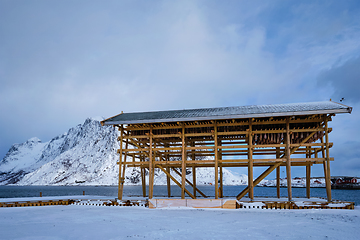 Image showing Drying flakes for stockfish cod fish in winter. Lofoten islands, Norway