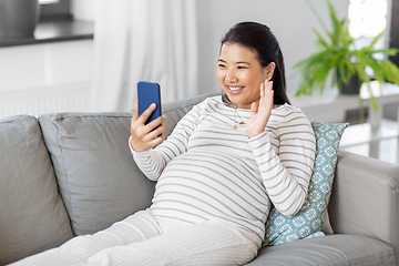 Image showing happy pregnant woman having video call on phone