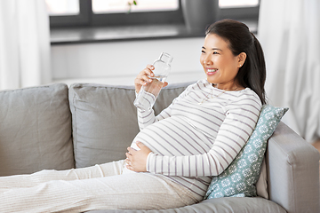 Image showing pregnant woman with water in glass bottle at home