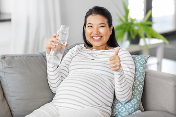 Image showing pregnant woman with water in glass bottle at home