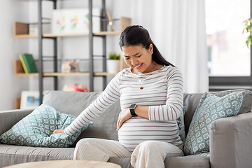 Image showing pregnant woman having labor contractions at home