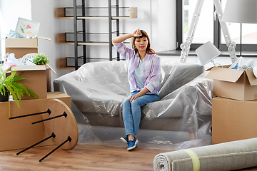 Image showing tired asian woman with stuff moving to new home