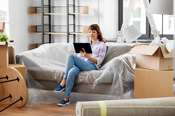 Image showing asian woman with tablet pc moving into new home