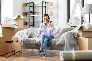 Image showing happy woman calling on phone moving to new home