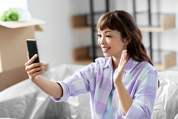 Image showing woman having video call and moving into new home