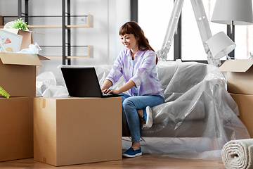 Image showing woman with laptop moving into new home