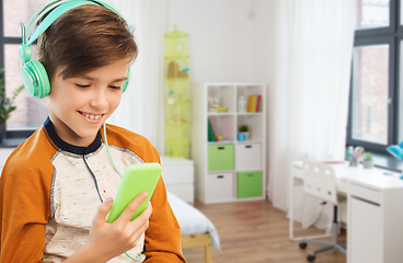 Image showing happy boy with smartphone and headphones at home