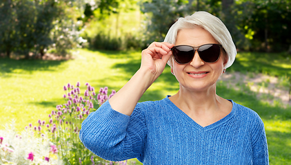 Image showing smiling senior woman in black sunglasses