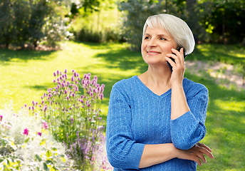 Image showing smiling senior woman calling on smartphone