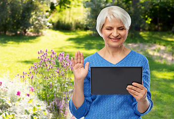 Image showing senior woman having video call on tablet computer