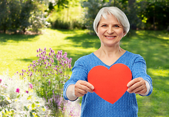 Image showing smiling senior woman with red heart