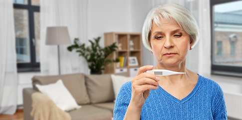 Image showing sick senior woman with thermometer