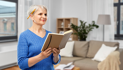 Image showing senior woman with pencil and diary or notebook