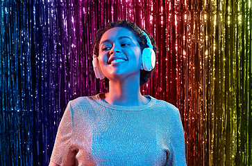 Image showing woman in headphones listening to music at party