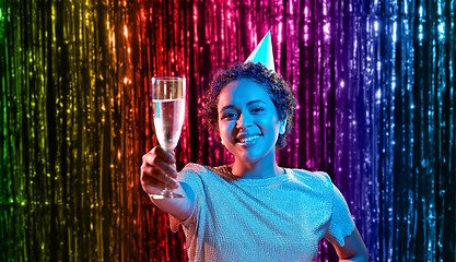 Image showing african woman in party cap with glass of champagne