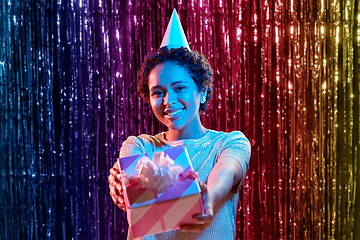 Image showing african woman in birthday party cap with gift box