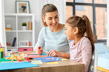 Image showing daughter with mother making applique at home