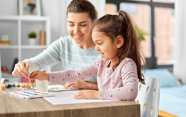 Image showing mother with little daughter drawing at home