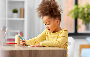 Image showing little girl with felt pen drawing picture at home