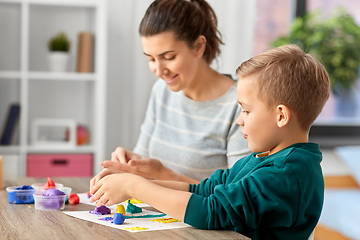 Image showing mother and son playing with modeling clay at home