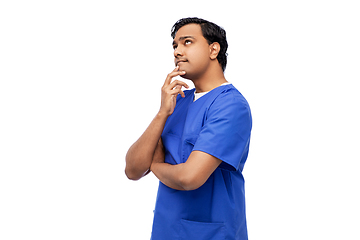 Image showing thinking indian male doctor in blue scrubs