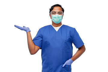 Image showing indian male doctor in mask holding something