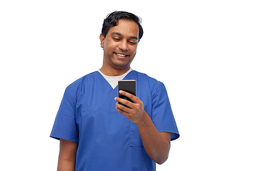 Image showing smiling doctor or male nurse using smartphone